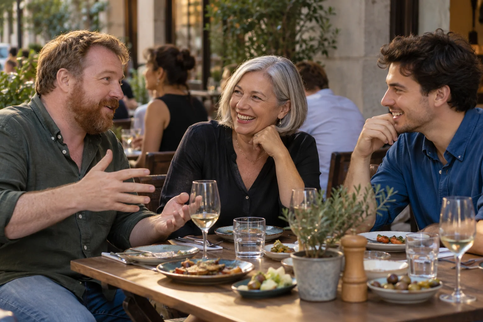 A team sharing dinner on a city terrace — a fictional scene