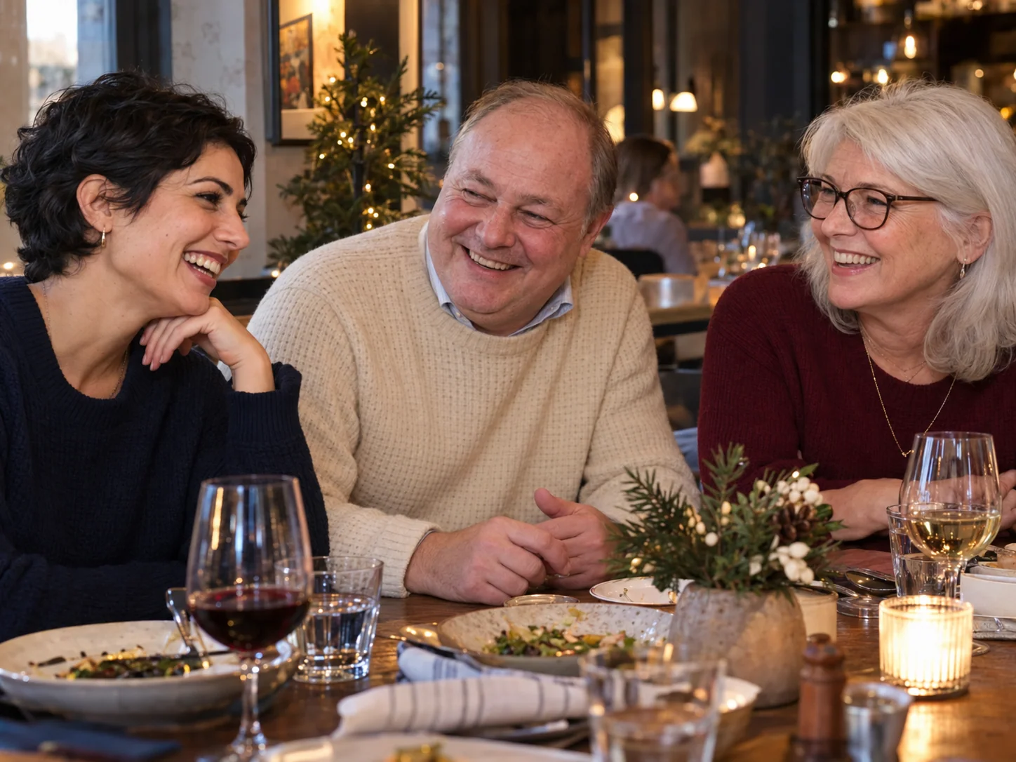 Fictional colleagues share a conversation at a winter holiday supper.